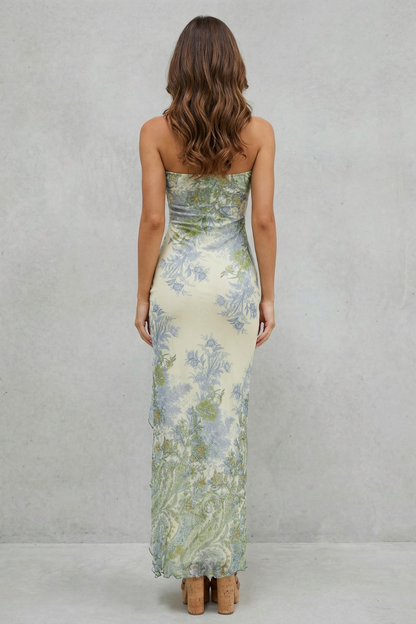 Back view of a strapless cream maxi dress with a blue and green floral print, highlighting the fitted silhouette.