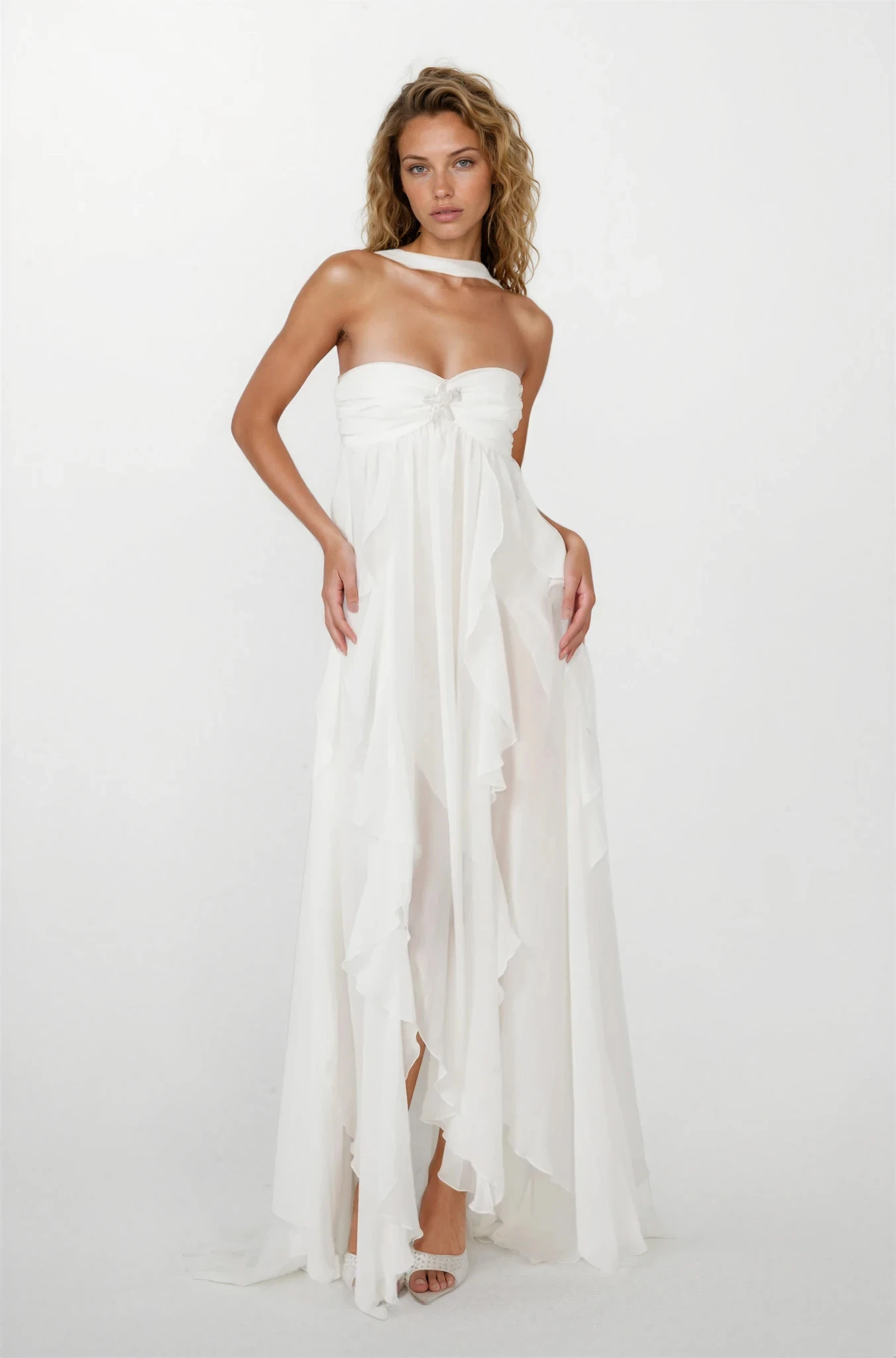Front view of a women's white strapless ruched ruffle maxi dress with a starfish brooch and a high-low hem.