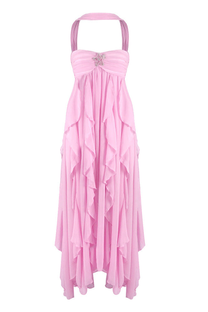 Pink strapless ruched ruffle maxi dress with a halter neckline and a silver star embellishment on the bust.