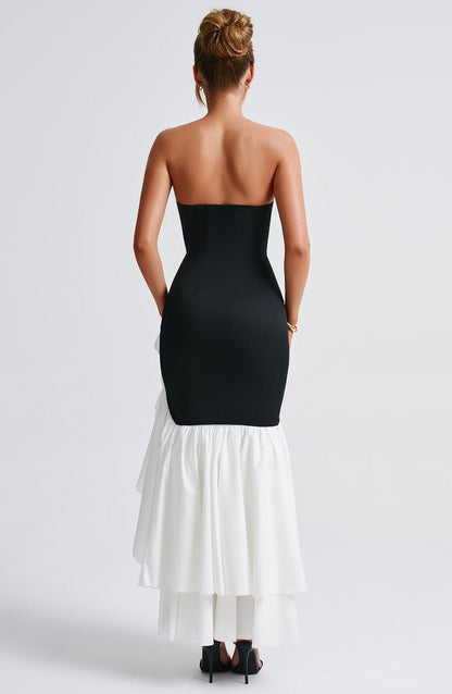 Back view of the black and white strapless ruffle high-low maxi dress, showing the layered white skirt.