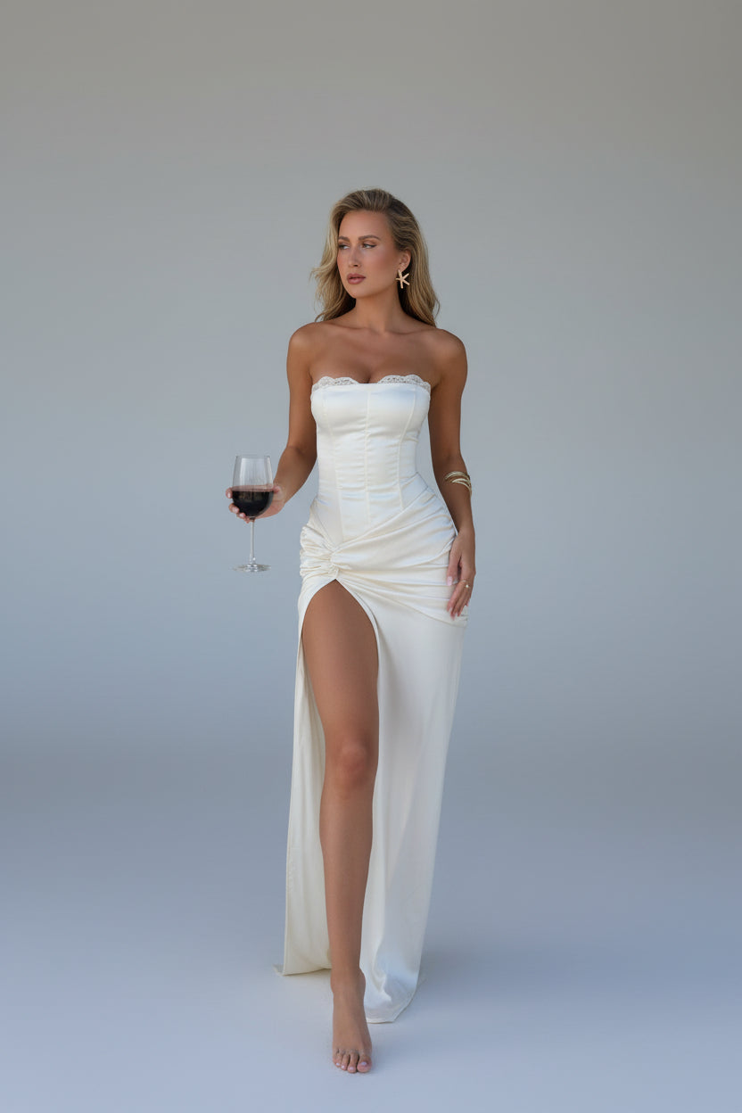 Elegant white satin dress with strapless lace corset bodice and thigh-high slit, perfect for vacation outfits.