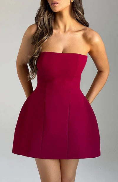 Close-up front view of the deep berry red strapless bubble mini dress, showing the seaming details on the bodice and skirt.