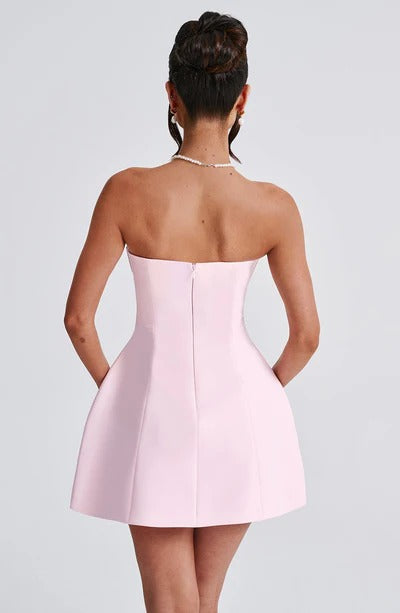 Back view of the light pink strapless seamed bubble mini dress, emphasizing the clean lines and elegant silhouette.