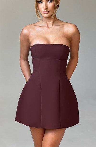 Front view of a rich burgundy strapless seamed bubble mini dress, featuring a structured bust and A-line skirt.