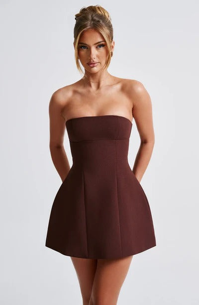 Full front view of a dark brown strapless seamed bubble mini dress, highlighting the tailored seams and elegant silhouette.