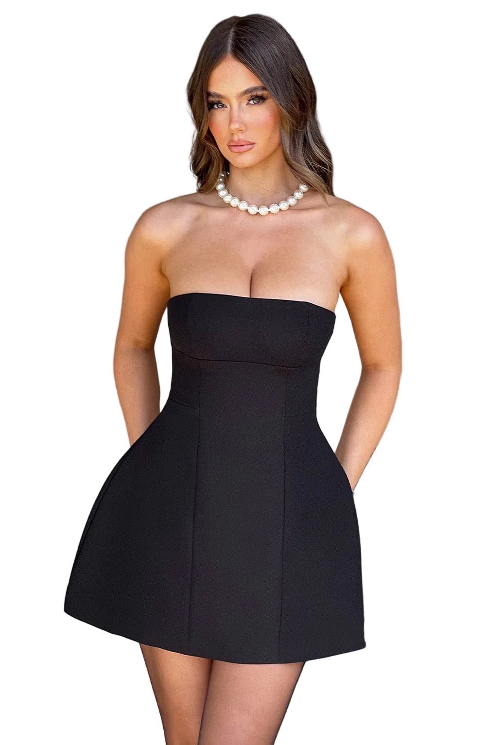 Black strapless seamed bubble mini dress with a fitted bodice and flared skirt, paired with a pearl necklace.