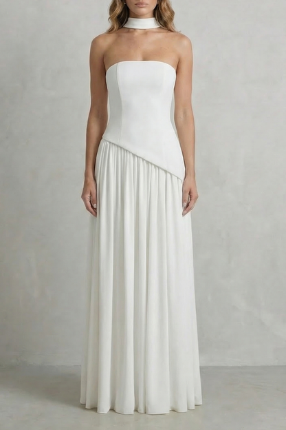 Elegant white strapless maxi dress with draped bodice and flowing skirt, perfect for wedding guests or vacation outfits.