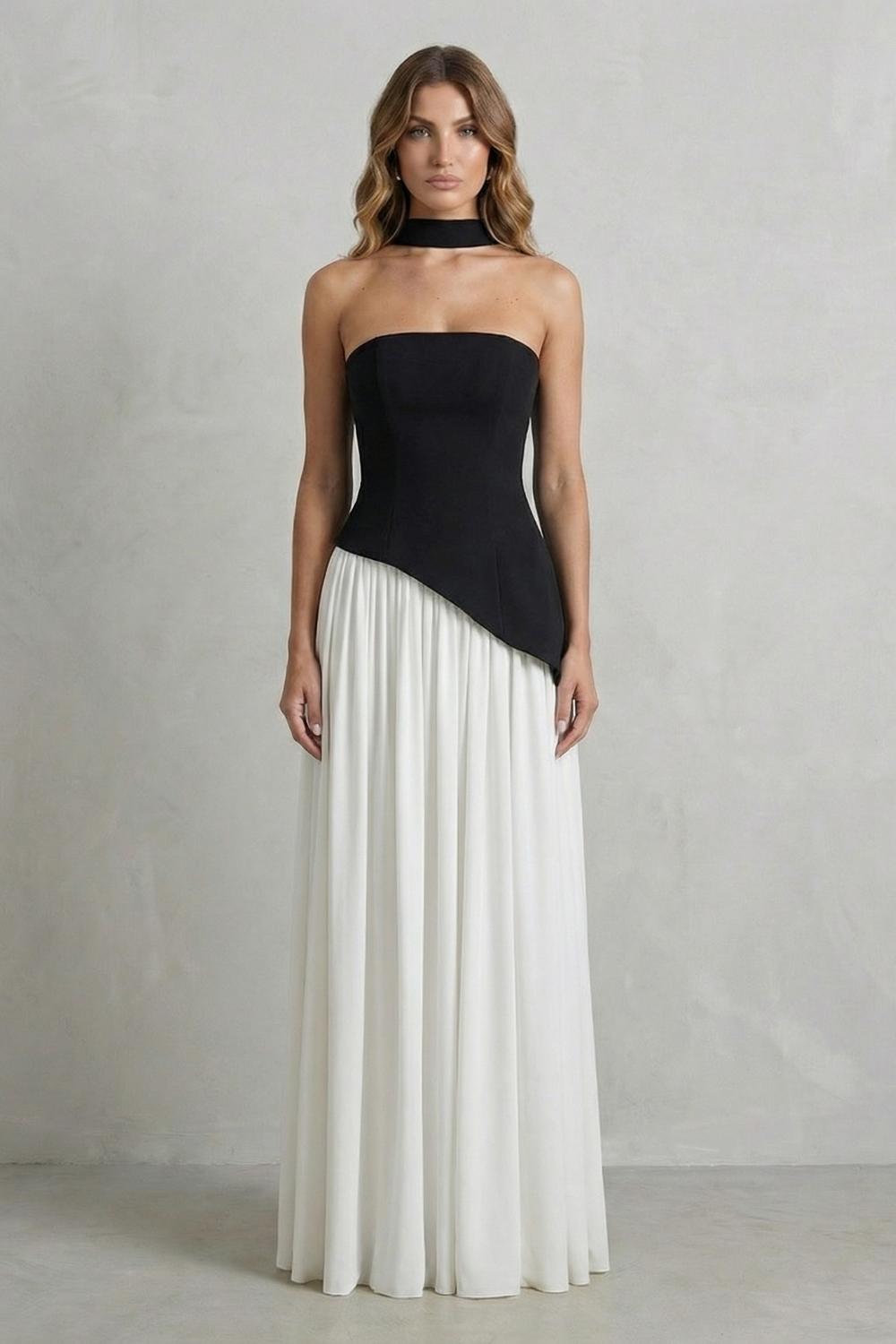Two-tone black and white strapless maxi dress, showing the draped black top and a full white skirt, a stylish vacation outfit.