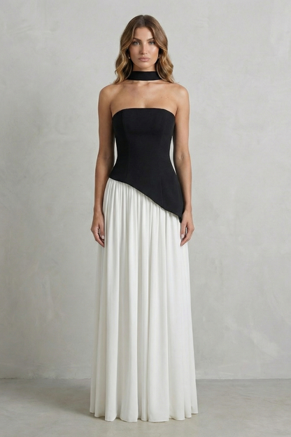Two-tone black and white strapless maxi dress, showing the draped black top and a full white skirt, a stylish vacation outfit.