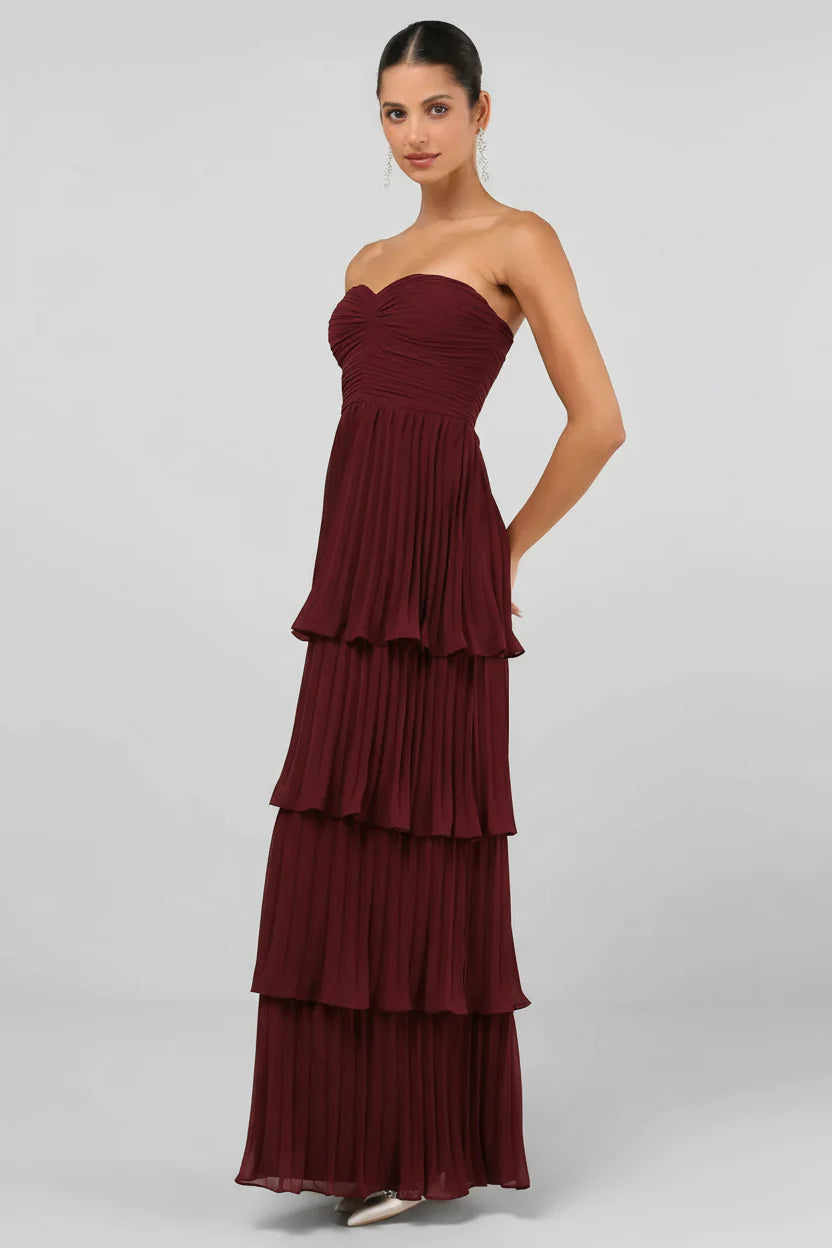 Side view of the burgundy strapless tiered pleated maxi dress, highlighting the delicate pleating.
