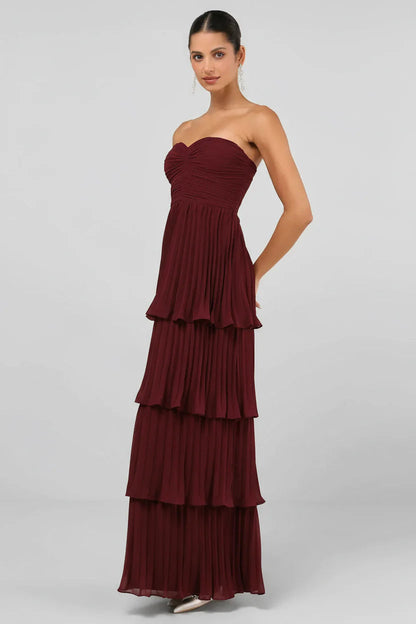 Side view of the burgundy strapless tiered pleated maxi dress, highlighting the delicate pleating.