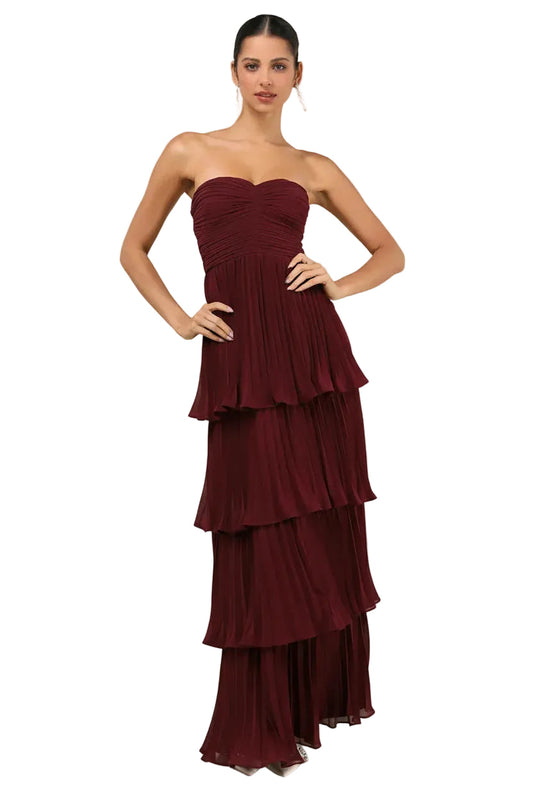 Front view of a women's strapless tiered pleated maxi dress in a rich burgundy color, perfect for wedding guests.