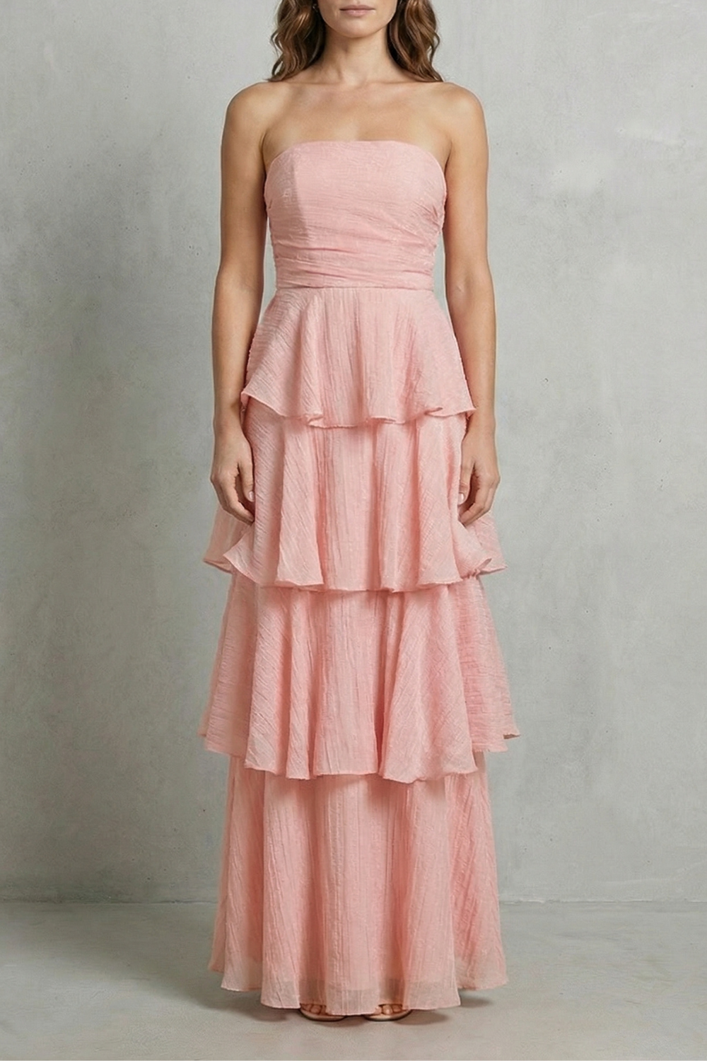 Full-length view of a soft pink strapless tiered ruffle maxi dress, elegant for summer events.