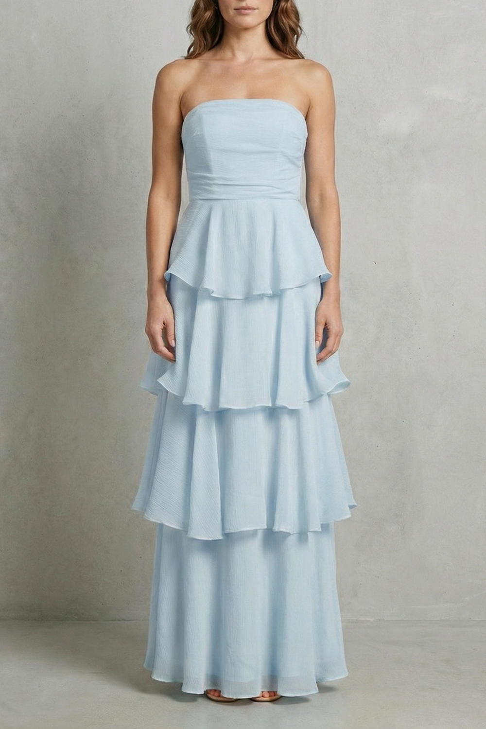 Full-length view of a light blue strapless tiered ruffle maxi dress, perfect for a beach dress.