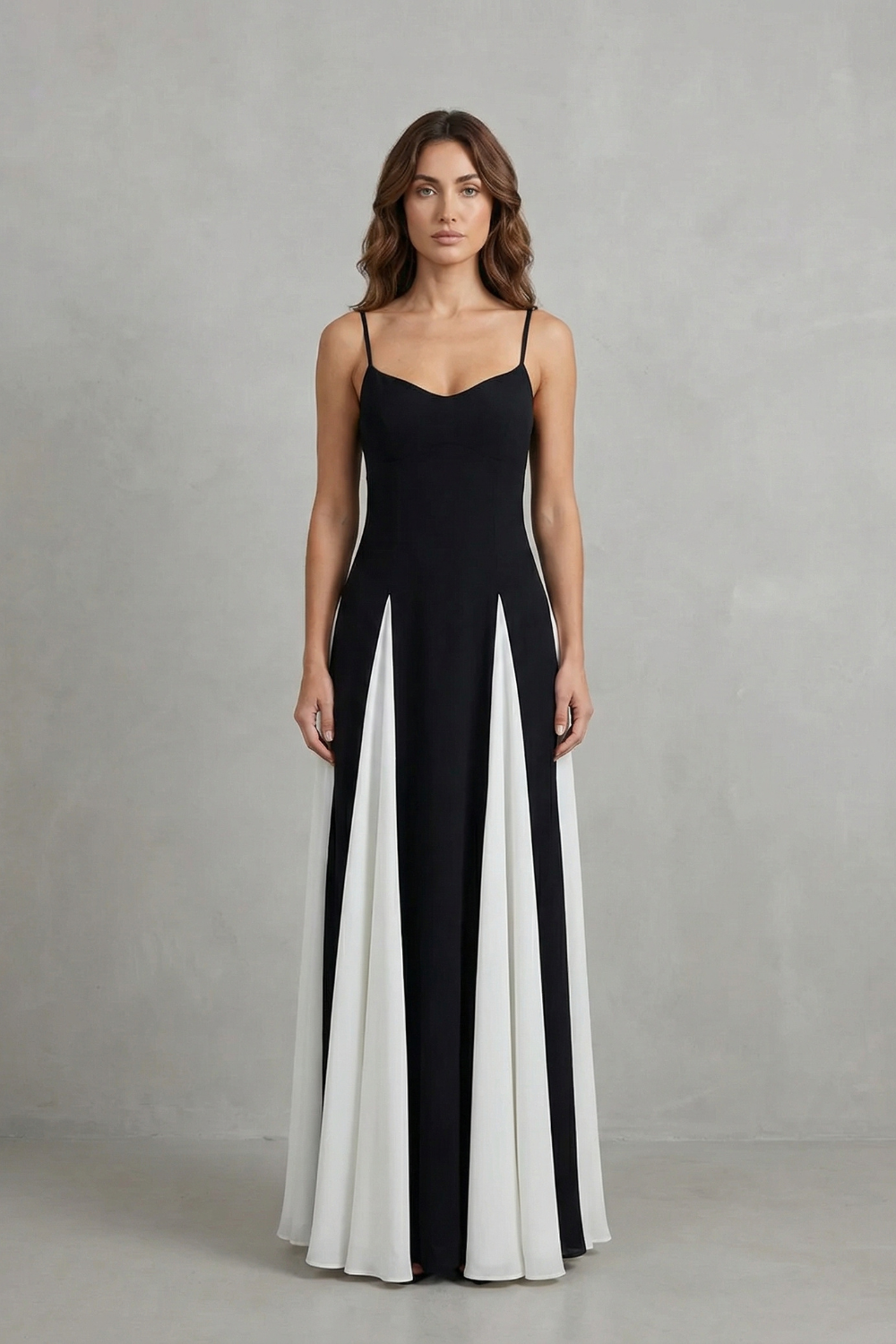 Front view of a women's elegant black and white maxi dress, featuring a sweetheart neck and flowing skirt panels.