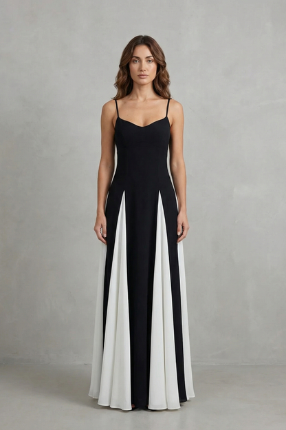 Front view of a women's elegant black and white maxi dress, featuring a sweetheart neck and flowing skirt panels.