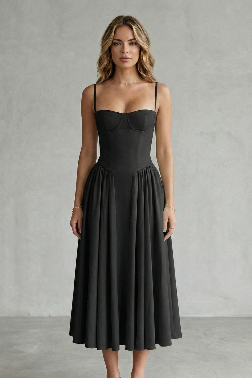 Front view of a woman wearing a classic black strappy structured sweetheart neck midi dress, a versatile midi dress for women.