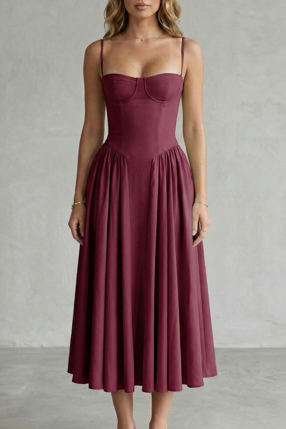Burgundy red structured sweetheart neck midi dress with thin straps and pleated skirt, perfect for vacation dresses.