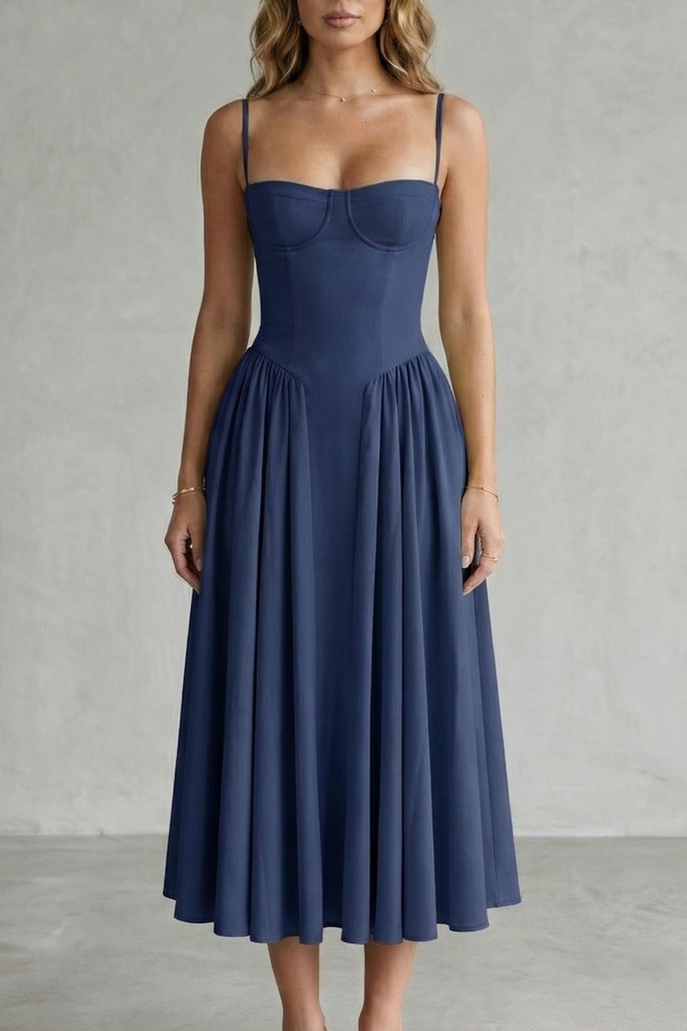 Navy blue structured sweetheart neck midi dress featuring thin straps and a voluminous pleated skirt, a chic midi dress.