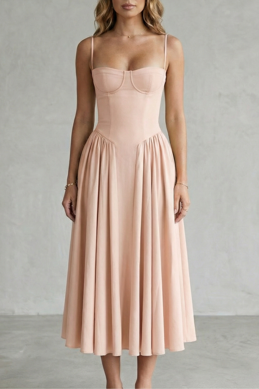 Blush pink structured sweetheart neck midi dress with thin straps and a flowing pleated skirt, a lovely beach dress for women.