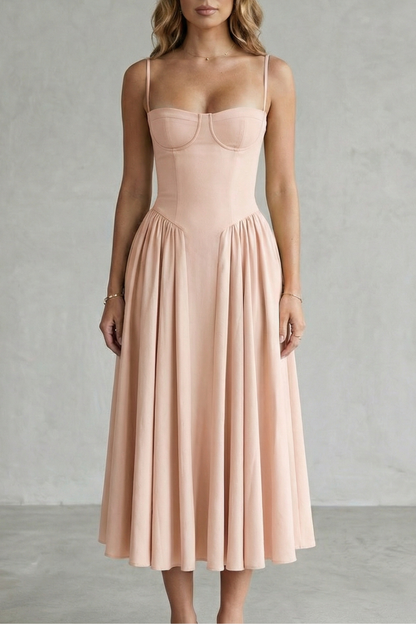 Blush pink structured sweetheart neck midi dress with thin straps and a flowing pleated skirt, a lovely beach dress for women.