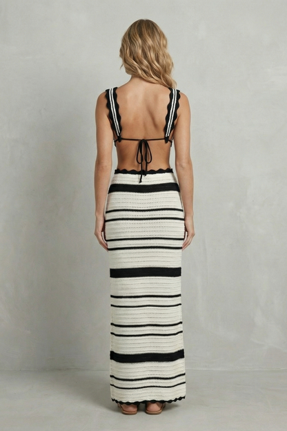 Back view of a women's striped scalloped crochet maxi skirt set with a tie-back top and long skirt.