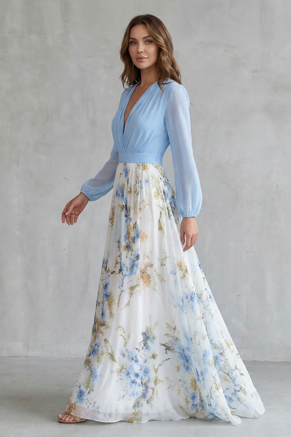 Side view of a women's summer floral V-neck maxi dress, showing the flowy white skirt with blue and gold floral print and light blue long sleeves, perfect for vacation dresses.