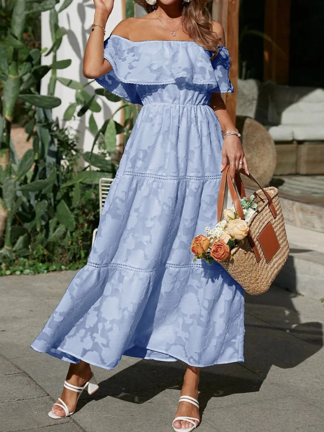 Women's light blue off-shoulder tiered maxi dress with subtle floral texture, elastic waist, and ruffle detail. Perfect vacation dress.