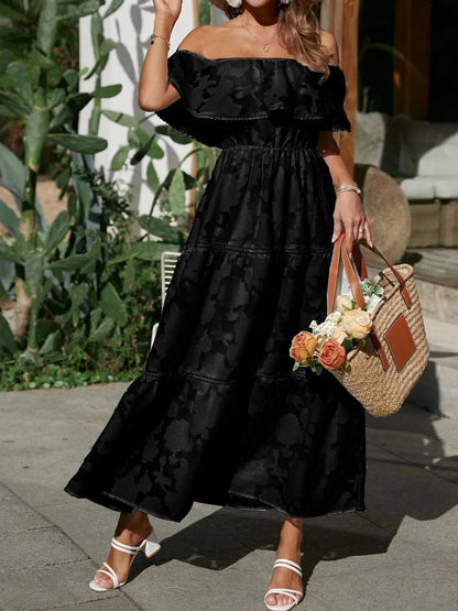 Front view of a black off-shoulder tiered maxi dress for women, featuring a subtle floral texture and ruffled neckline. Elegant dress.