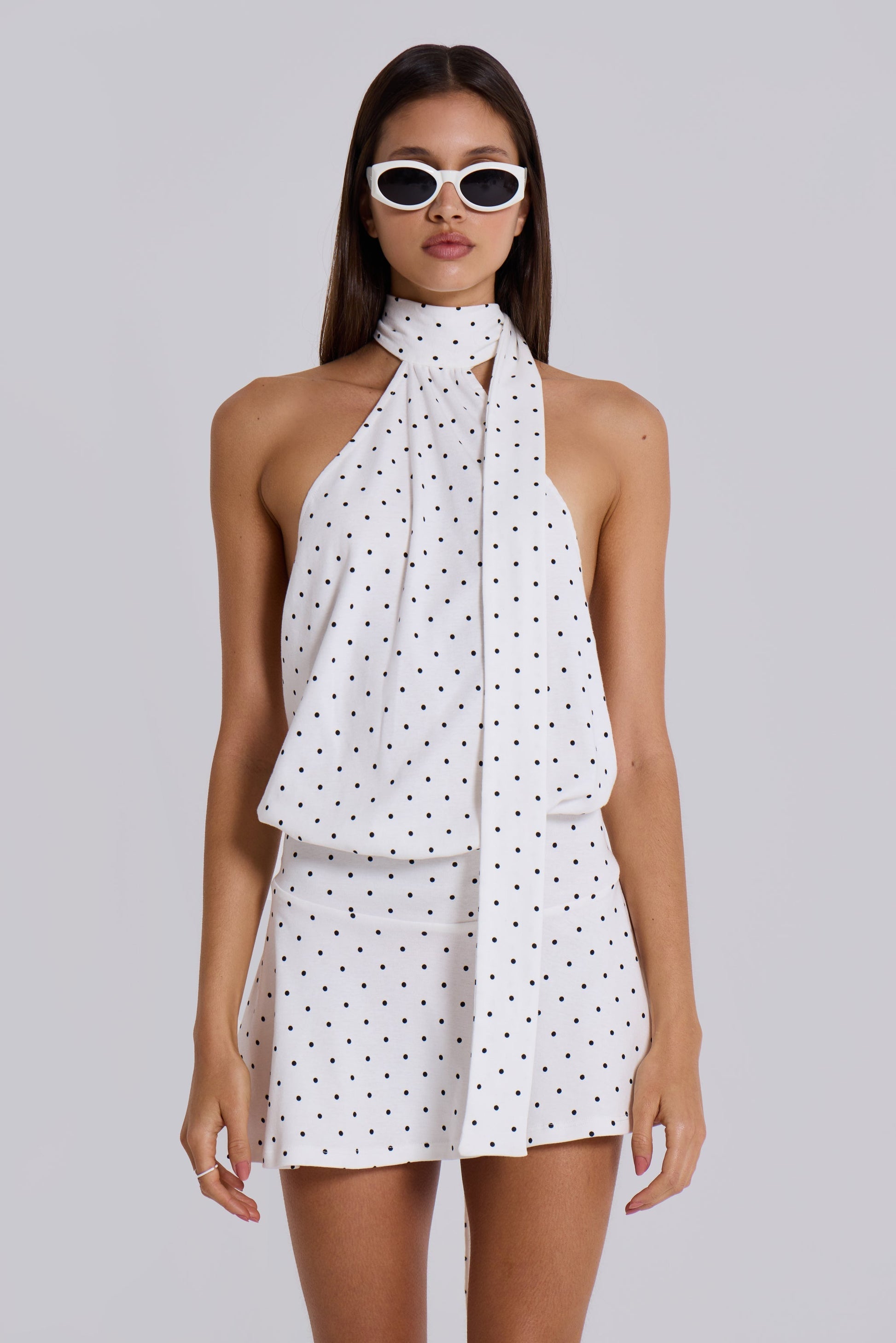 Upper body view white polka dot halter mini dress with scarf tie neck and draped bodice, front shot