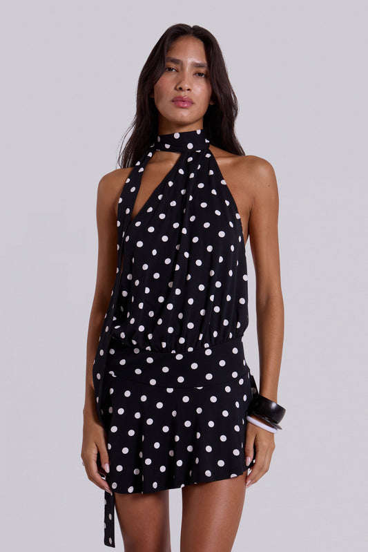 Black polka dot halter mini dress with keyhole neckline and gathered waist, front close-up