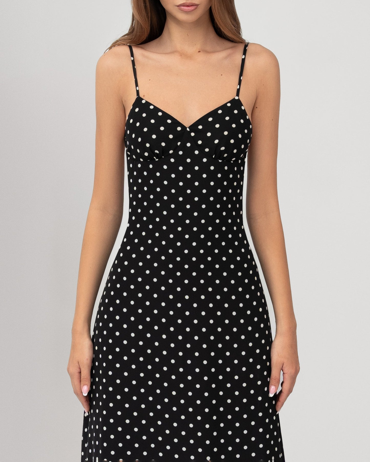 Close-up of sweetheart bodice on black and white polka dot maxi dress with thin straps