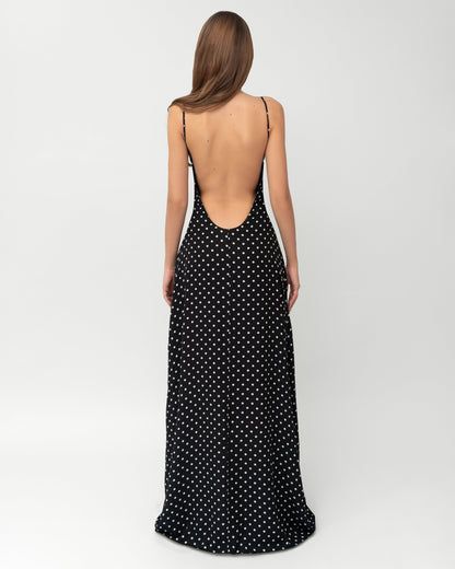 Full back view of black and white polka dot maxi dress with deep open back and center zipper