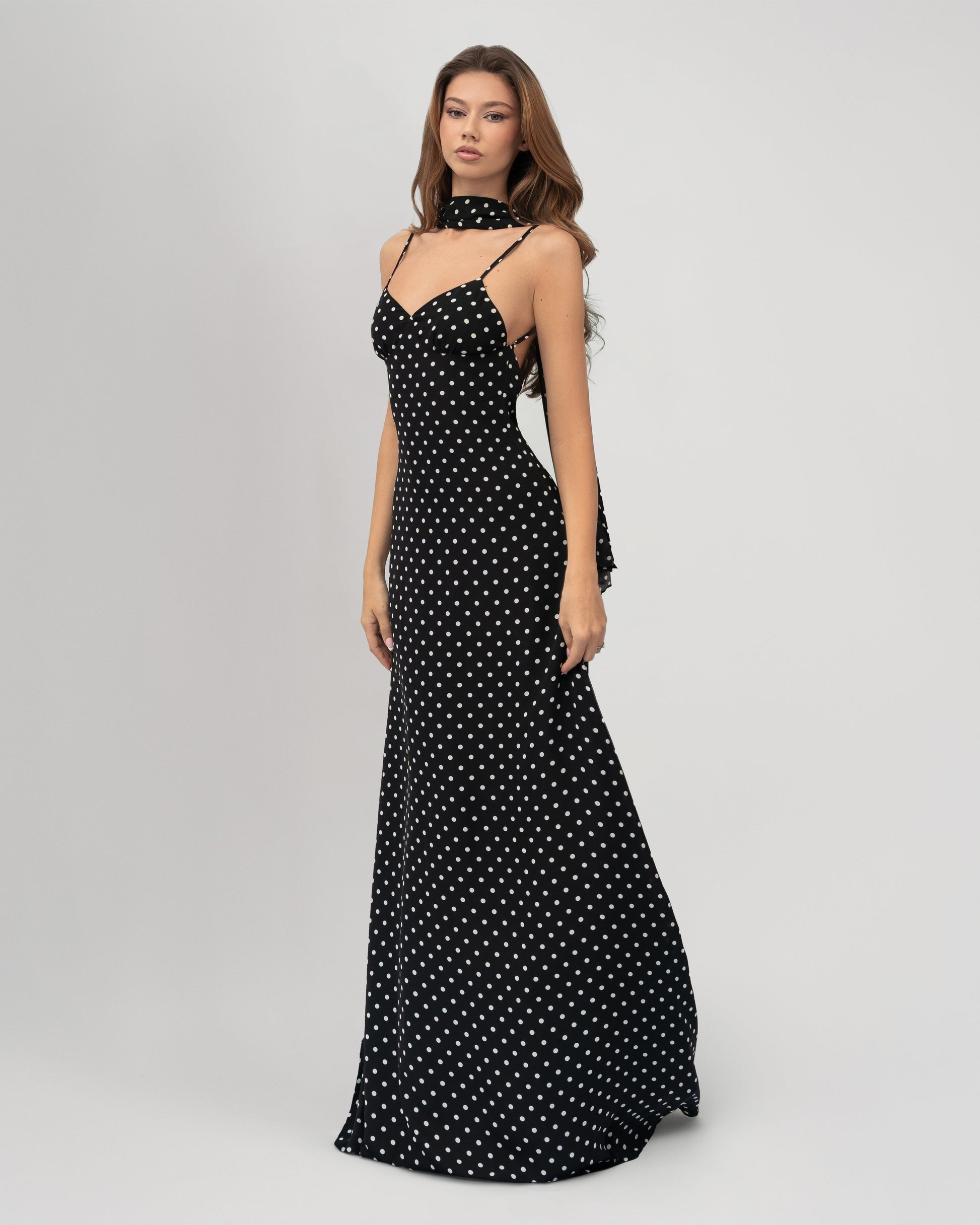 Black and white polka dot sweetheart open back maxi dress with spaghetti straps and neck scarf