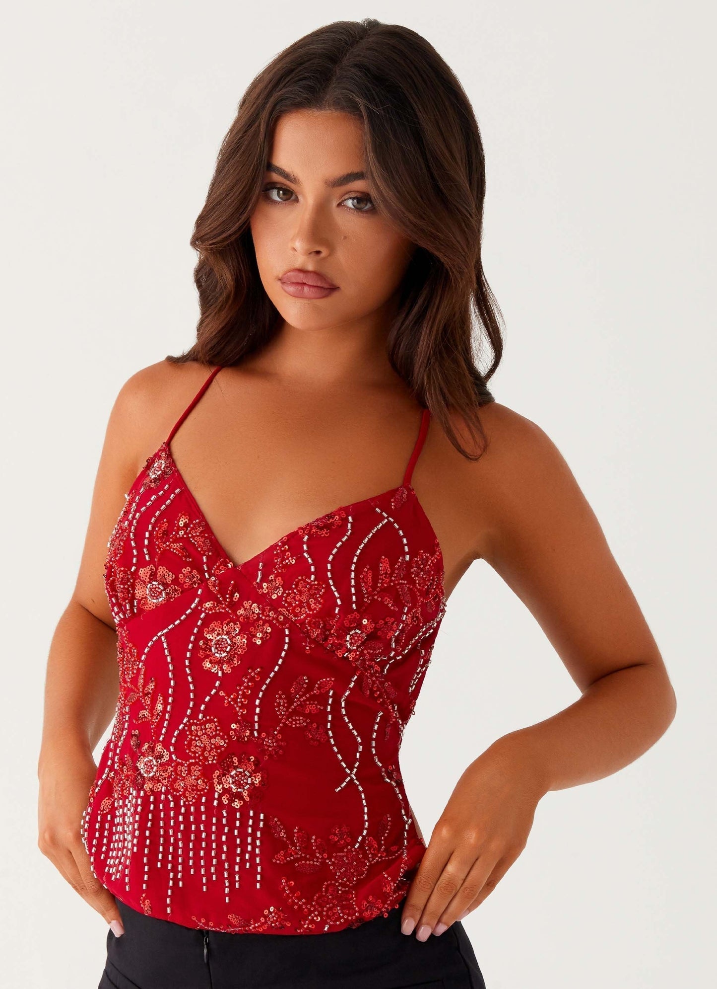 Red spaghetti strap V-neck crop top with floral sequin beadwork, close-up front detail