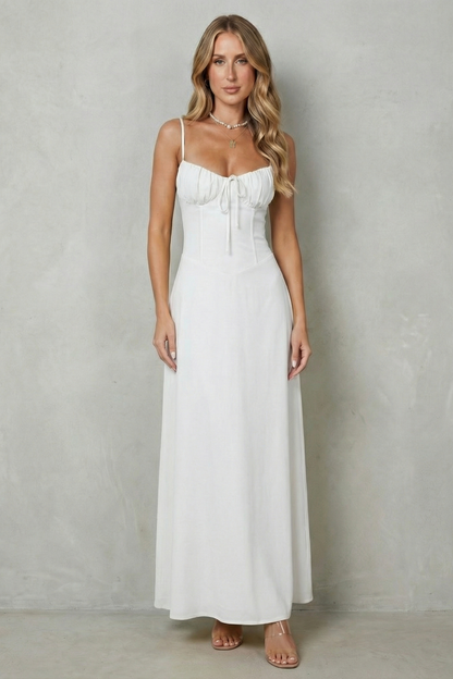 Full-length front view of a women's pristine white maxi dress, featuring a sweetheart neckline and a flowing skirt, perfect for a beach dress.
