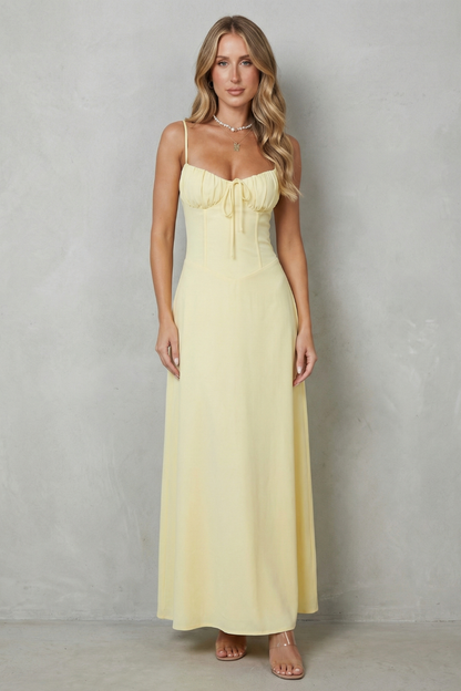 Full-length front view of a women's elegant yellow maxi dress, featuring a sweetheart neckline and a cinched waist design.