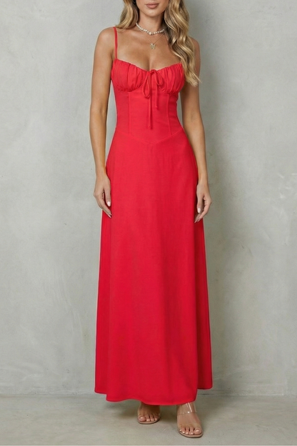 Front view of a women's red sweetheart neck maxi dress with a ruched bust and spaghetti straps, a vibrant choice for wedding guests.
