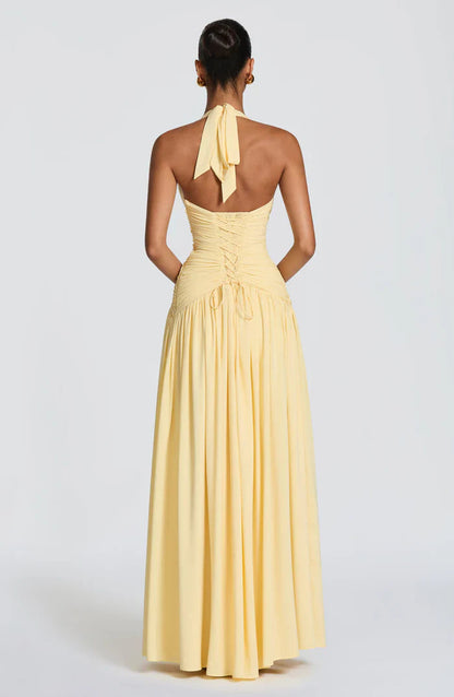 Pale yellow halter maxi dress back view with tie neck bow and lace-up corset waist