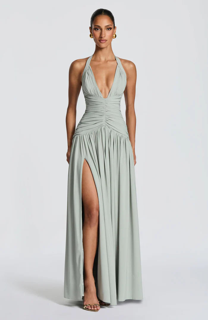 Sage green halter maxi dress front view with deep v-neckline, ruched waist and flowy skirt