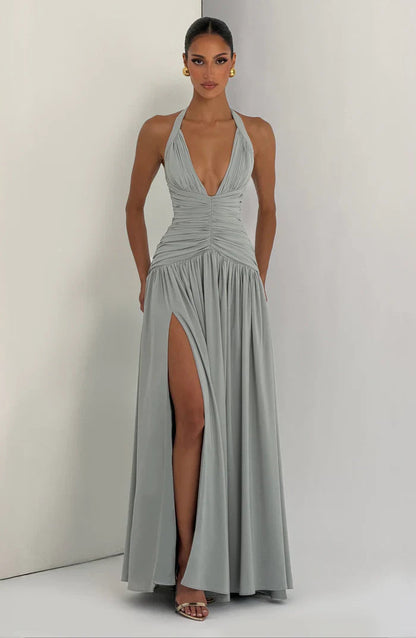 Sage green halter maxi dress full length front view with ruched waist, deep v-neck and slit