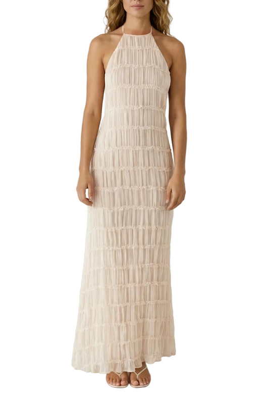 Full-length view of a light pink textured halter maxi dress with open back detail, perfect for vacation outfits.