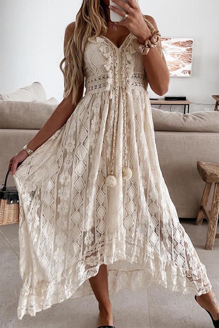 Women's white floral lace maxi dress with V-neckline and asymmetrical hem, close up on texture