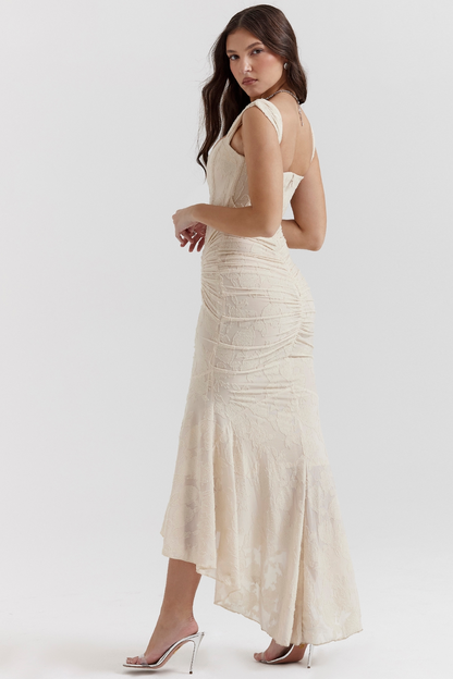Back view of an ivory floral lace midi dress, showcasing the ruched detail and flowing skirt for vacation outfits.