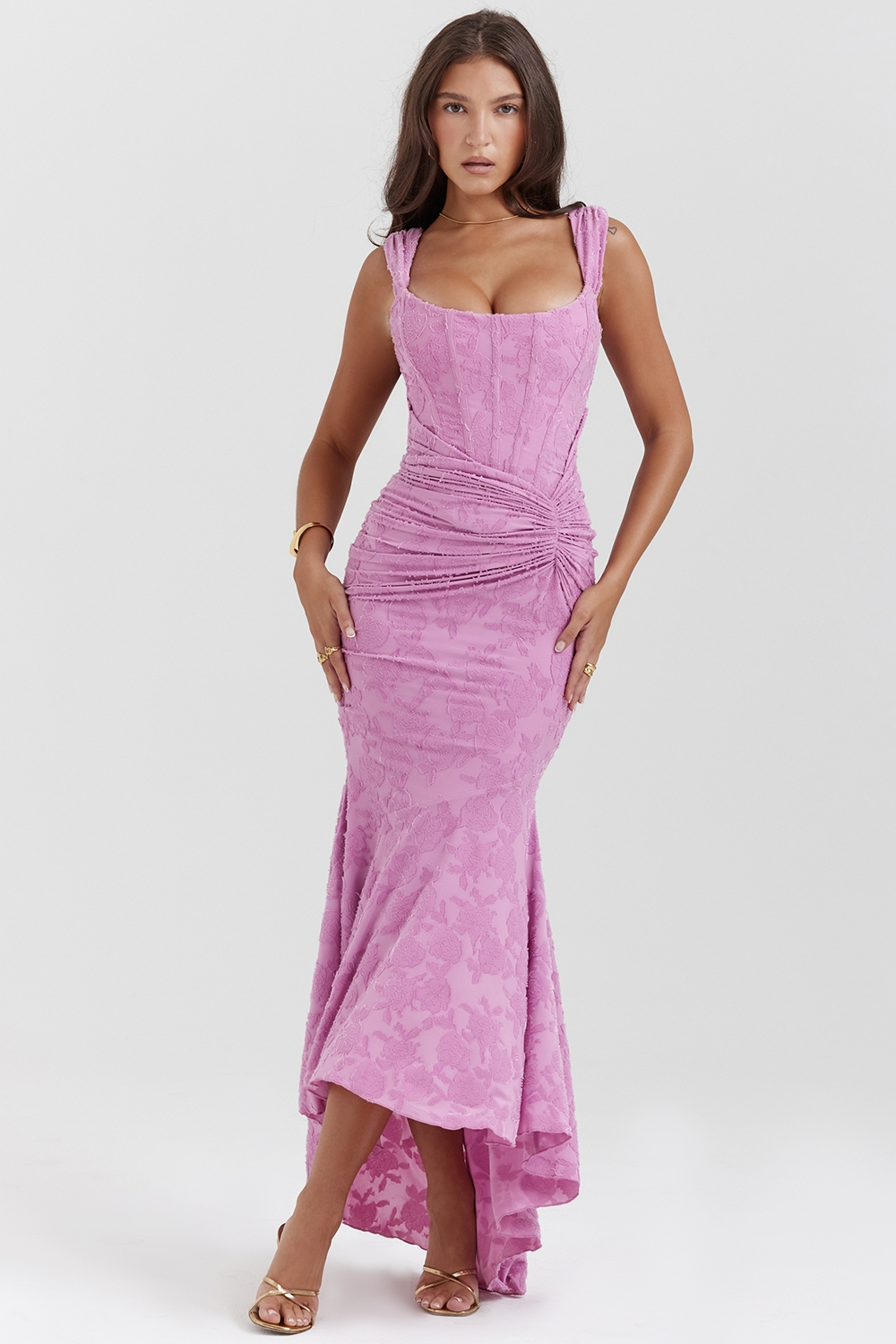 Front view of a women's lavender bodycon midi dress with a floral lace texture and ruched bodice, perfect for wedding guests.