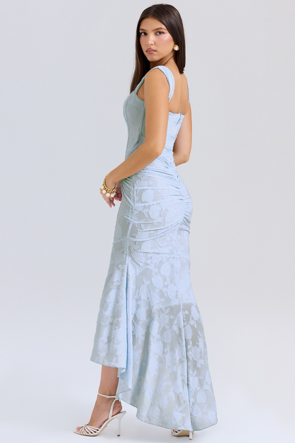 Side view of a light blue floral lace midi dress showing the ruched back and elegant high-low mermaid style, ideal for special occasions.