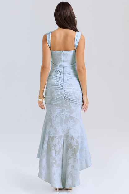 Back view of a light blue floral lace midi dress with ruched detailing on the bodice and a flowing high-low hem.