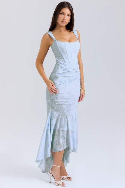 Three-quarter view of a light blue floral lace midi dress featuring a fitted bodice, ruched waist, and a stylish high-low skirt.