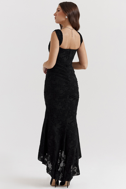 Back side view of a black floral lace midi dress, showcasing the ruched back and the elegant high-low hemline.