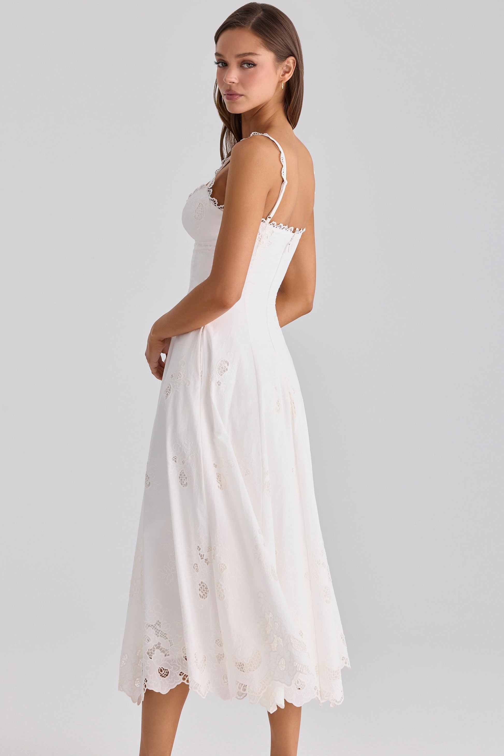 Angled back view of white maxi dress with lace neckline trim, slim straps, and back zipper